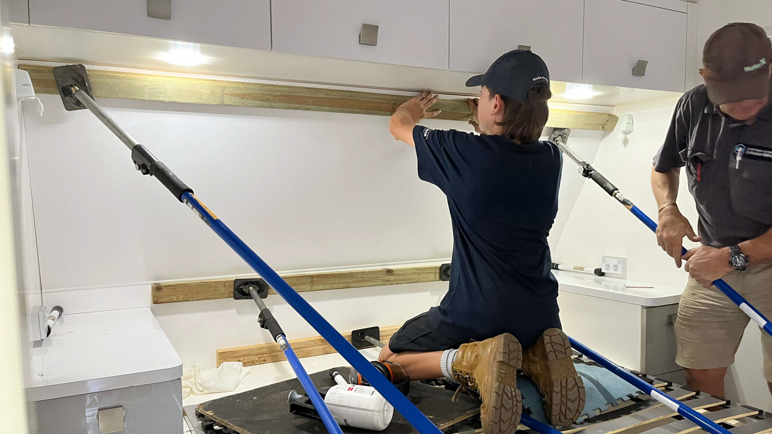 Northern Rivers Caravan Repairs technicians using support poles while upgrading the interior of a caravan.